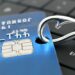Beware of Phishing Scam Emails - Concept credit card on a fishing hook on computer keyboard