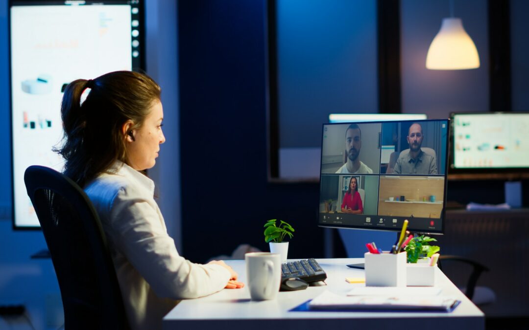 Businesswoman talking during video conference with team in midnight