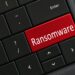 Ransomware concept - Computer Keyboard with red RANSOMWARE. Hacked virus hijacked cyber attack